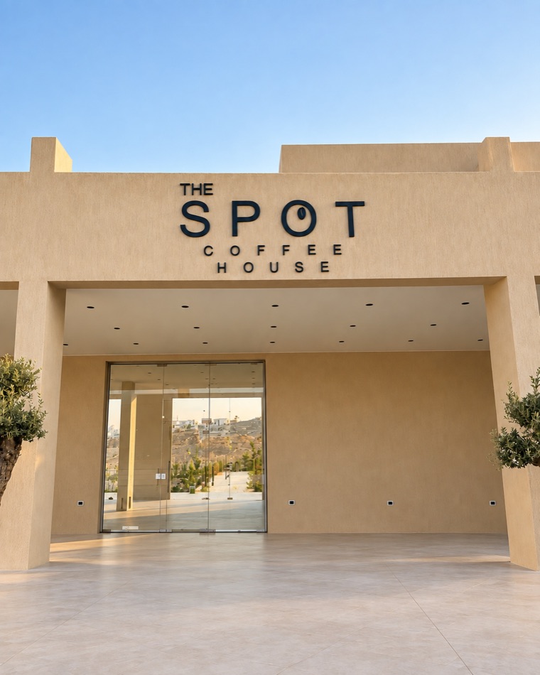Entrance of The Spot Coffee House with olive trees on each side